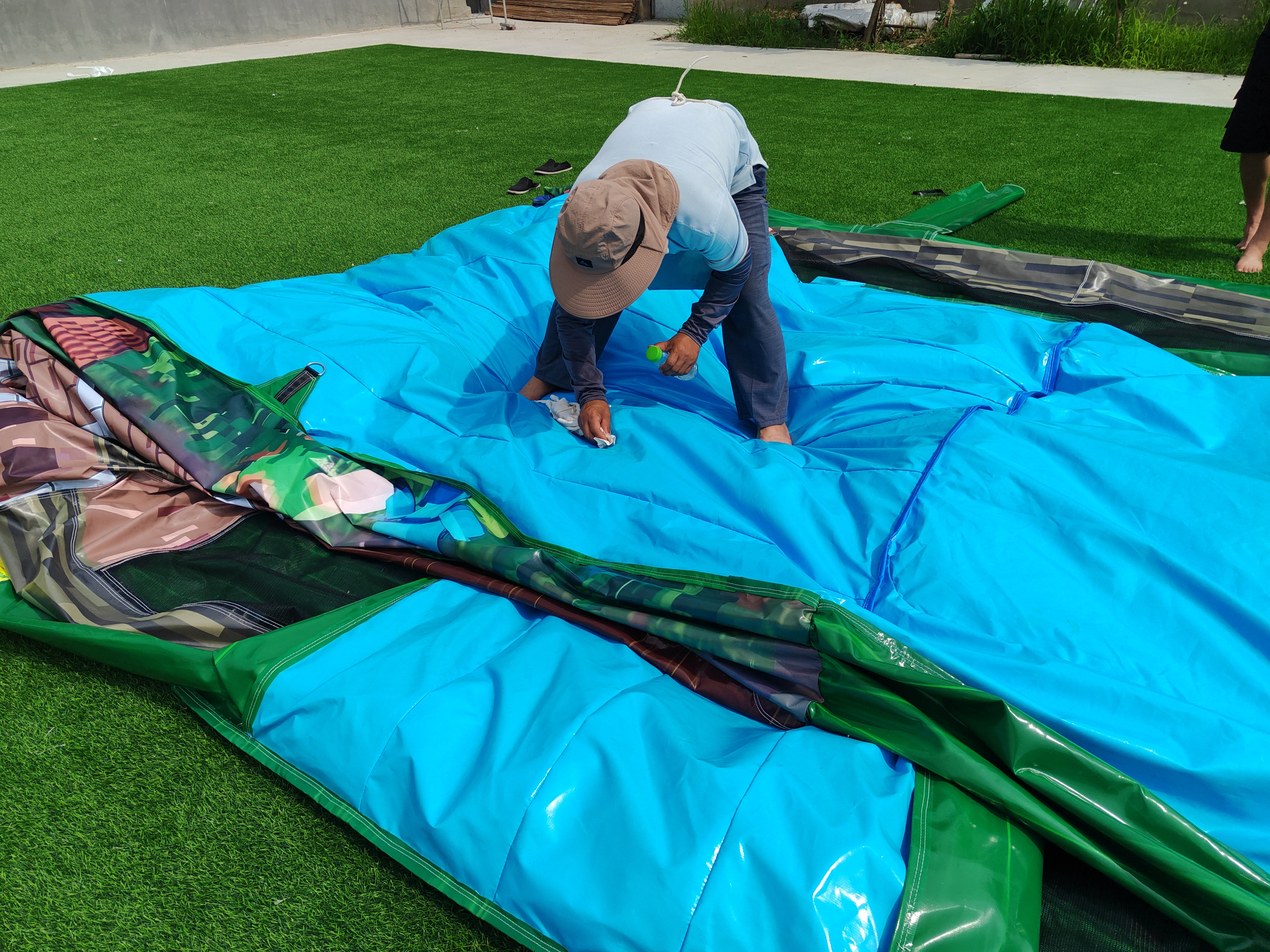 Quality control inspector performing inflation test on finished inflatable product