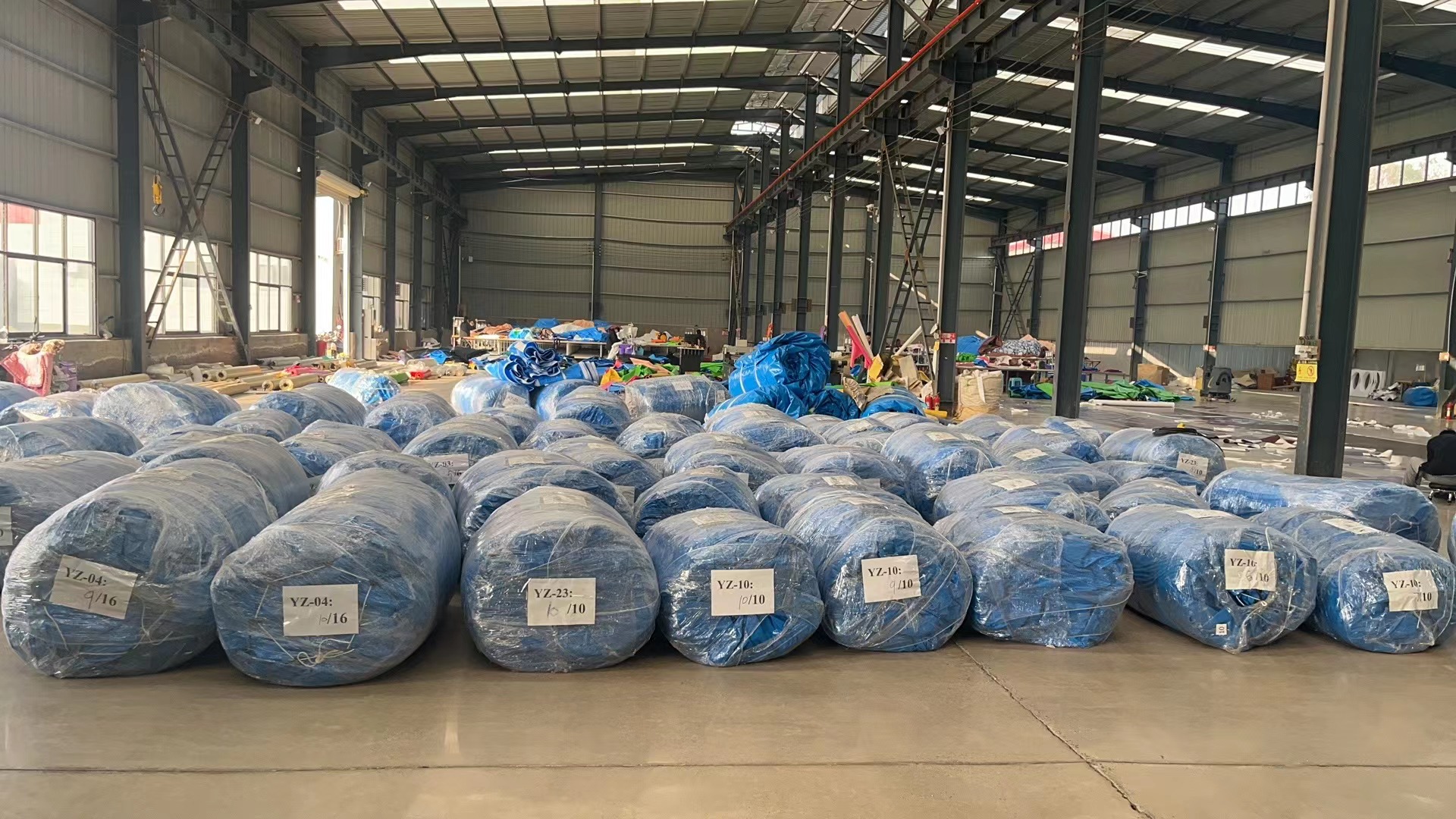 Worker packaging finished inflatable product with reinforced wrapping for shipping